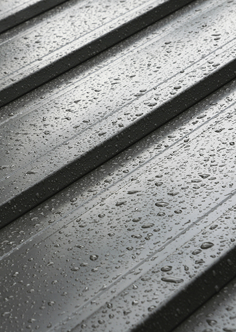 dark metal roof detail with raindrops